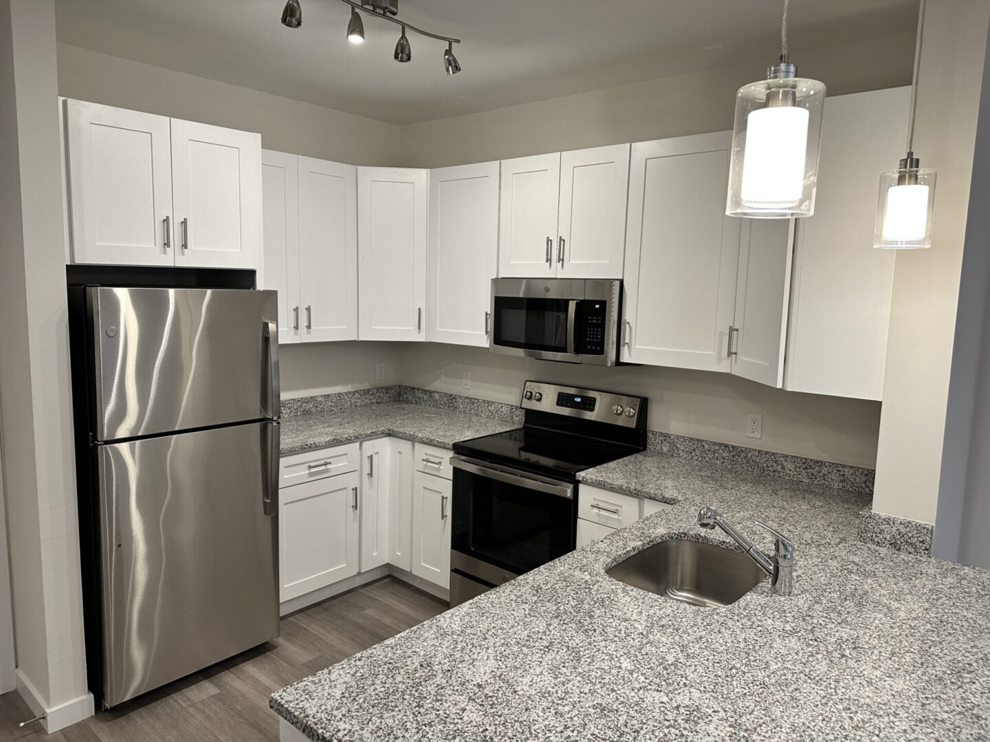 kitchen with white cabinets and gray marble counters