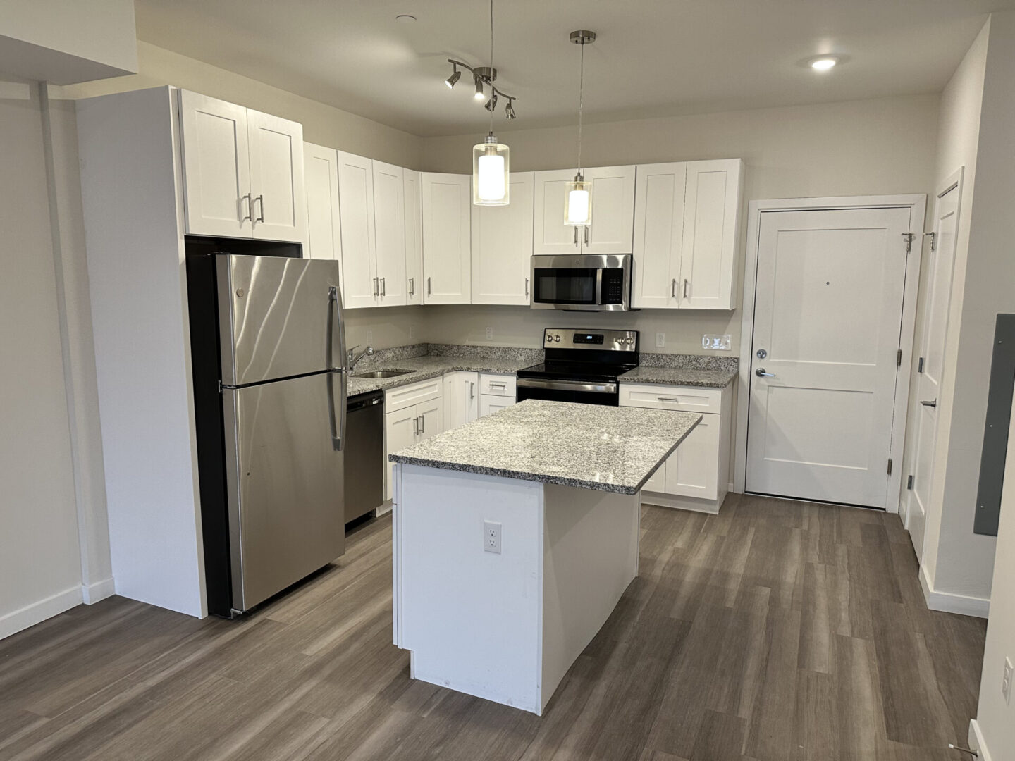 kitchen with wooden floor tiles and gray marble counters